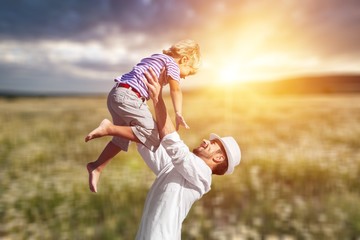 Family happy outside sunset vacation lifestyle hug