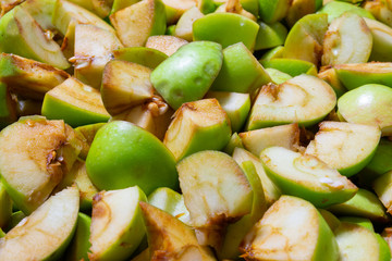 Bright green apples in the cut close-up, macro fruit, small slices with DOP effect, diet food for fitness and children.