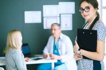 Doctor and patient discussing something while sitting at the table . Medicine and health care concept