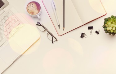 Modern workplace with laptop, notebook, pen and cup of coffee