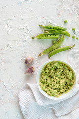 guacamole creamy sauce for toast bread with avocado and peas, mexican food