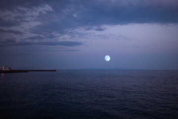 北の海に昇る満月