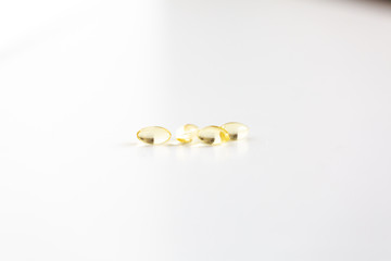 Group of Yellow Pills on White Background, CBD Capsules, Vitamins