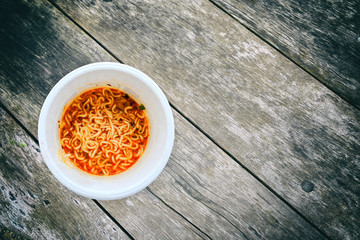 Instant noodles  bowl placed on an old wooden table