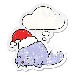 cartoon christmas walrus and thought bubble as a distressed worn sticker