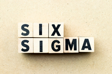 Letter block in word six sigma on wood background