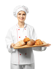 Female chef with bakery products on white background