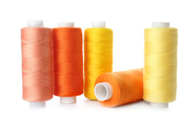 Bright sewing threads on white background