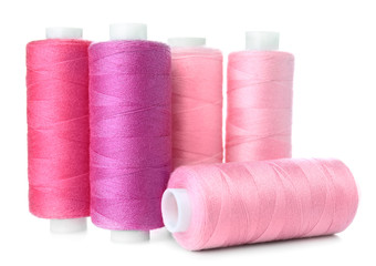 Bright sewing threads on white background