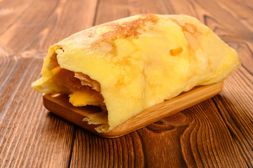 roll with egg and shredded pork and barbeque pork with some bites close up