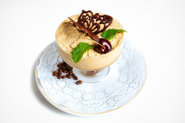Sweet dessert in glass with biscuit, chocolate, berry fruit and whipped cream. Isolated on a white background. 