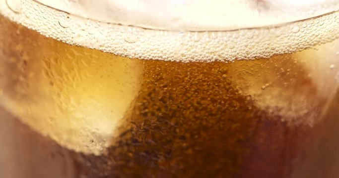 Slow motion macro close up, fizzy bubbles in a carbonated beverage