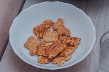 cookies in a white cup on the table