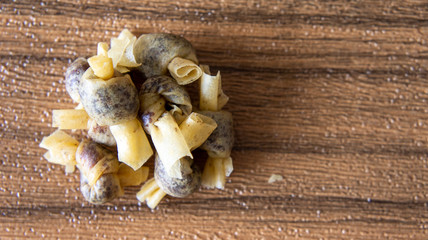 Traditional malay food or snack known as popia simpul kasih with seruding on wooden background.