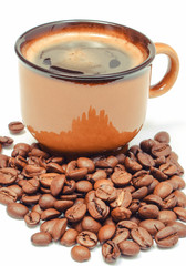 Heap of coffee grains and cup of beverage