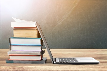 Stack of books with laptop