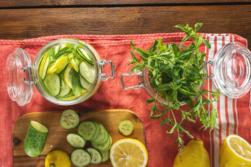 Cooking detox water cucumber drink top view. Dieting concept