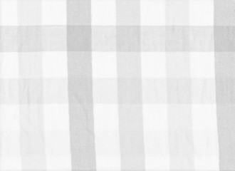 White and gray striped fabric background.
