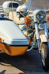 Retro tricar. Three-wheeled motorcycle on city street