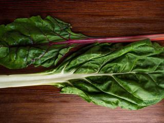 Raw mangold on wooden backgound, Fresh leaves of chard, close up
