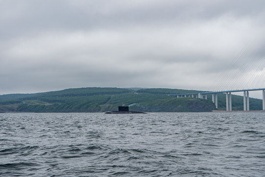 A line of modern russian military submarine cruisers in the row, northern fleet and baltic sea fleet in the open sea, submarine