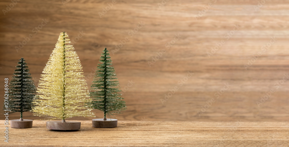 Aufkleber christmas tree on wood table with wooden wall for merry chirstmas and new year holiday greeting card