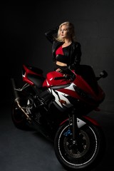 Obraz na płótnie Canvas Sexy woman sitting on a motorcycle shot