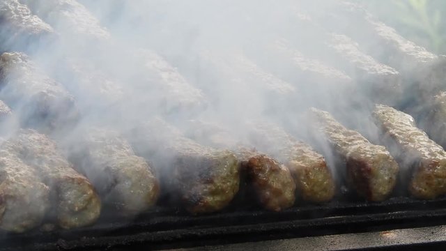 Traditional food Meat Balls "mici" on grill. Delicious food cooked. Mici on the grill (romanian meat balls)