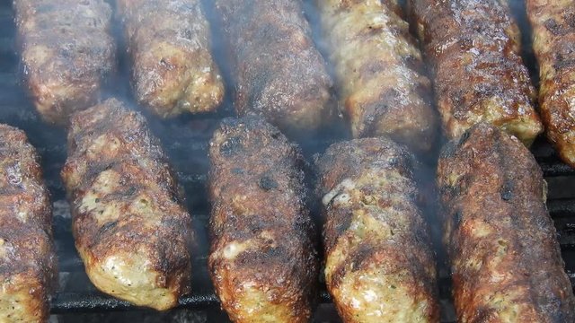 Traditional food Meat Balls "mici" on grill. Delicious food cooked. Mici on the grill (romanian meat balls)