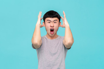 Aggressive angry young Asian man shouting