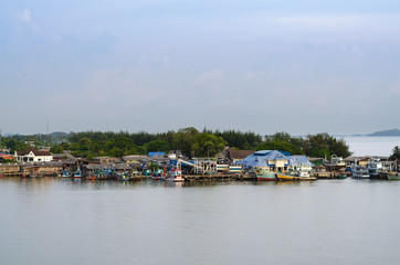 Fototapeta na wymiar Asian fishing village with boat is docked at the dock.