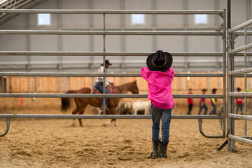 Cowboy kid watching at arena