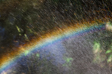Nice rainbow on splash water, abstract shape, close up photo, copy space