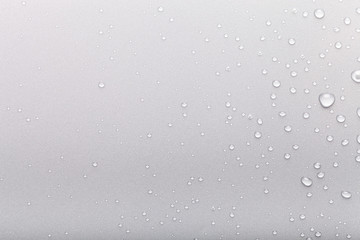 Drops of water on a color background. Gray