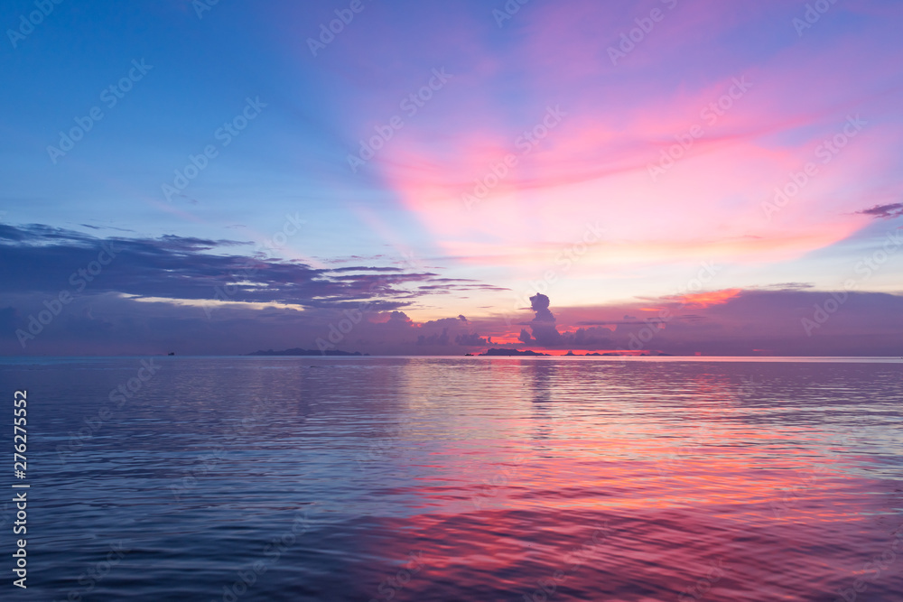 Wall mural beautiful tropical pink blue sea sunset and yellow clouds background