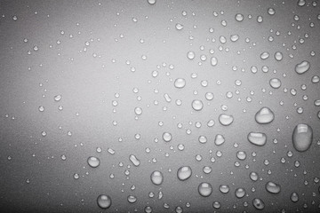 Drops of water on a color background. Dark grey. Toned