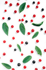 Fruit pattern made of fresh berries and green leaves on white background. Concept of healthy food. Flat lay, top view, copy space