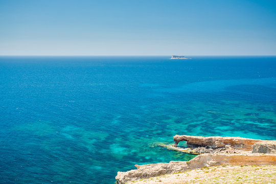 Fifla island and window near Tal-Ħamrija Coastal Tower, Malta