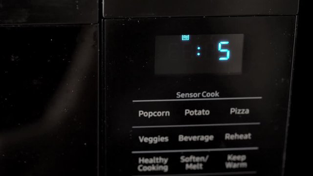 This macro closeup video shows a microwave digital screen monitor counting down and ending, from 10 seconds to 0 seconds.