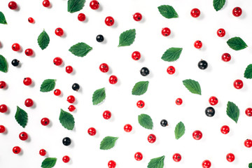 Fruit pattern made of fresh berries and green leaves on white background. Concept of healthy food. Flat lay, top view, copy space