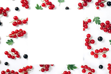 Fruit pattern made of fresh berries, green leaves and frame on white background. Concept of healthy food. Flat lay, top view, copy space