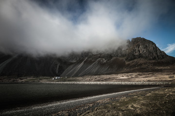 Beautiful spring sea landscape with low clouds in Iceland fjord. Toned