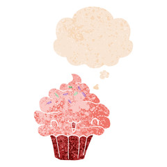 cute cartoon frosted cupcake and thought bubble in retro textured style