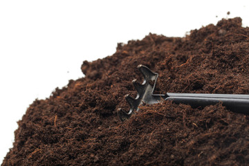 pile of soil with garden toos isolated on white background - Image .