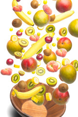 Fruits flying out of a wooden bowl on white background.