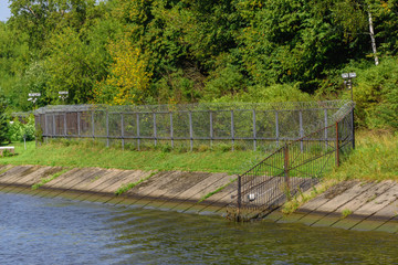 Metal fence with barbed wire and surveillance camera. Deny access.