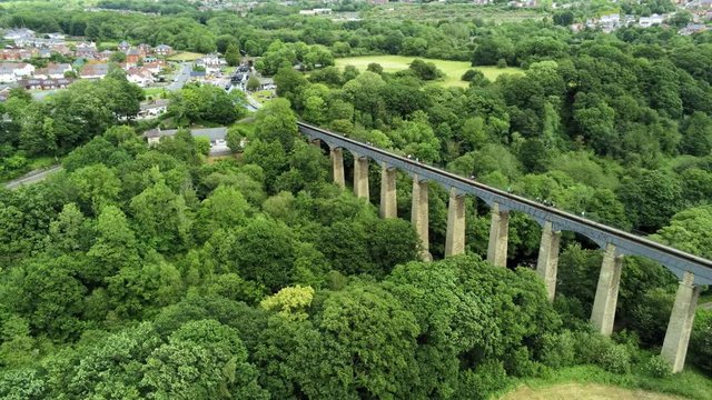 Pontcysyllte Aqueduct arch bridge canal waterway crossing. High altitude aerial view across structure landscape.