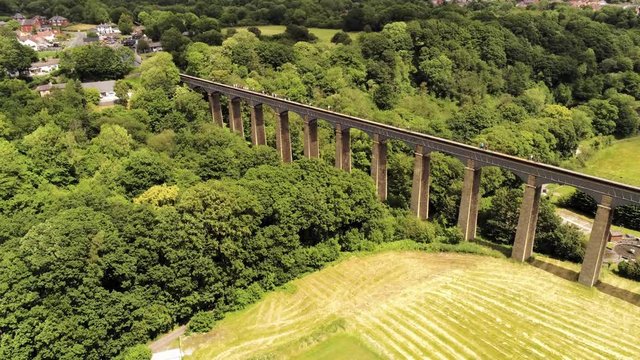 Pontcysyllte Aqueduct arch bridge canal waterway crossing. Ascending tilt down view across the canal.
