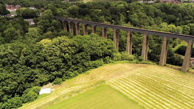 Pontcysyllte Aqueduct arch bridge canal waterway crossing. Ascending aerial view above the bridge.