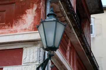 Old street lamps illuminate the way for passersby